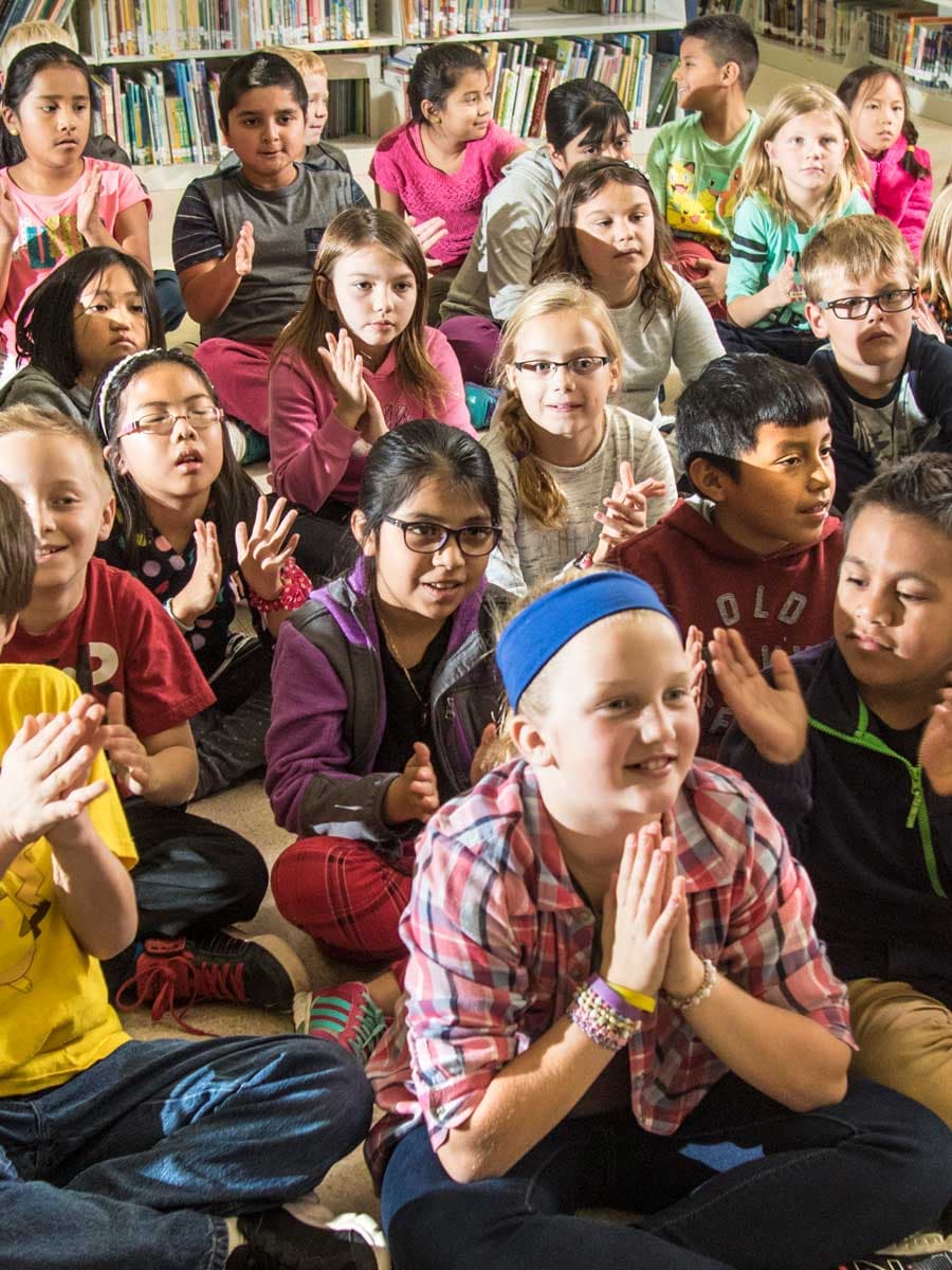 Children applaud after a performance.